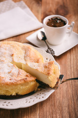 Homemade vanilla cheesecake and cup of coffee.