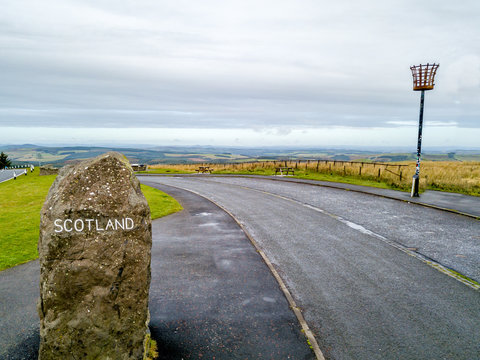 Aerial view of the border between Scotland and England with large stone and Scotland sign - United Kingdom