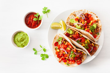 mexican beef and pork tacos with salsa, guacamole and vegetables
