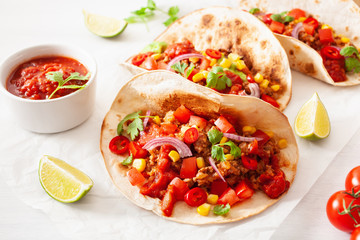 mexican beef and pork tacos with salsa, guacamole and vegetables