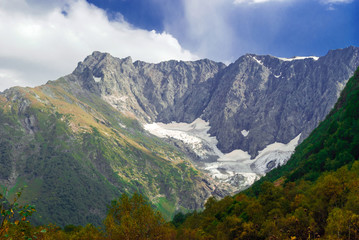 Fototapeta premium mountain landscape with a melting glacier in a valley in the North Caucasus