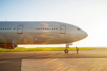 Large passenger aircraft ready to engine start in airport at sunset
