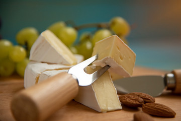 cheese camembert with raspberries and nuts on table
