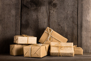 A gift of craft paper on an old wooden background.