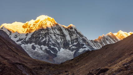 Annapurna south mountain during sunrise ( golden hour) being hit by first sunshine, Himalayas