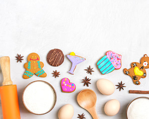 Obraz na płótnie Canvas Ingredients for making gingerbread - flour, sugar, eggs, cinnamon, cloves, nuts, bakeware, rolling pin on a gray concrete background Flat lay