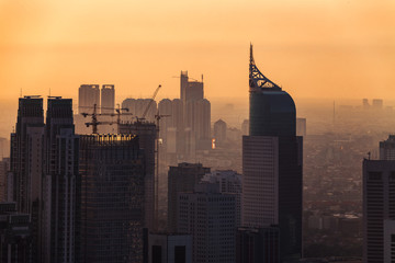 Aerial view of a hazy sunset over the skyline of downtown Jakarta Indonesia