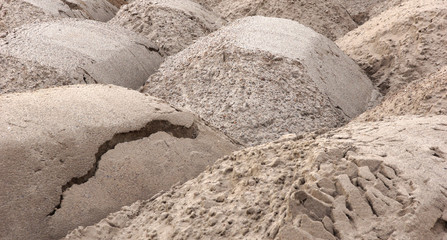 sand is piles of trucks brought for the construction of the building