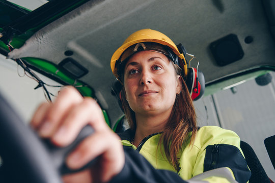 Close up portrait of woman operating front end loader heavy equipment