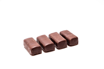 Chocolate candies on white background close up