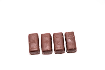 Chocolate candies on white background close up
