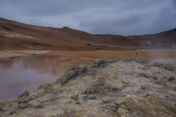 Tourists explore a geothermal area in Iceland