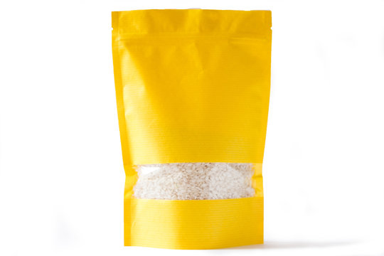 yellow paper doypack stand up bio pouch with window  zipper on white background filled with rice