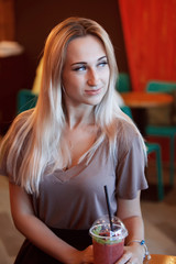 Beautiful Young Woman with Fruit smoothie