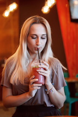 Beautiful Young Woman with Fruit smoothie