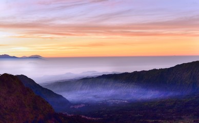 Fototapeta premium Morning in the Bromo Tengger Semeru National Park. Dense fog in the valley between volcanoes, Java Island, Indonesia