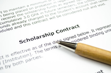 Scholarship contract with wooden pen 