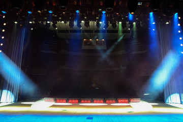 Illuminated empty concert stage with smoke