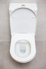 Close-up o white toilet bowl in bathroom