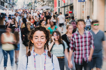 Young and attractive woman touring the city of Bordeaux in France. Standing on streets full of...