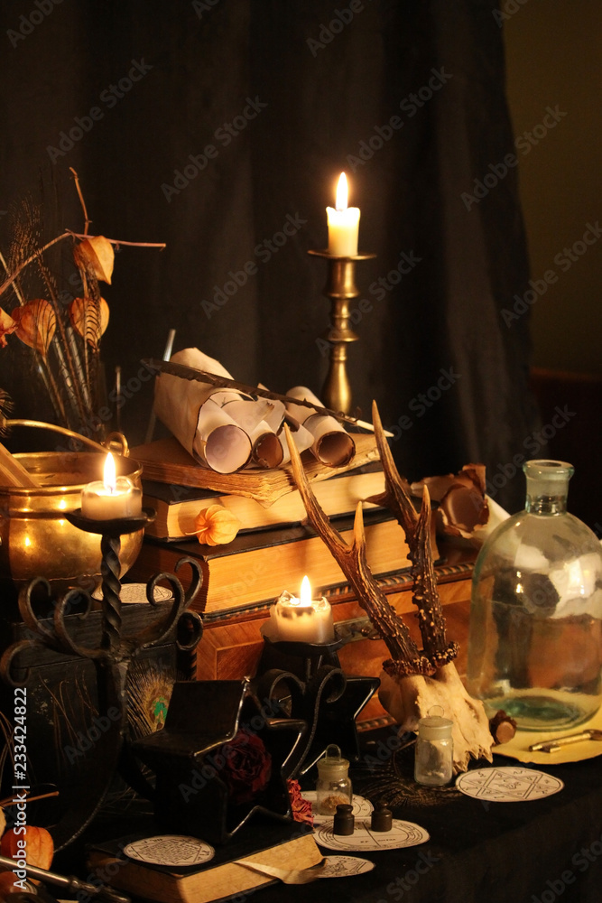 Wall mural Black candle Magic Ritual. Antique Magic Book. Witchcraft  Peacock feathers and candle background.