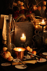 Black candle Magic Ritual. Antique Magic Book. Witchcraft  Peacock feathers and candle background.