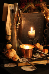 Black candle Magic Ritual. Antique Magic Book. Witchcraft  Peacock feathers and candle background.