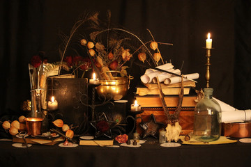 Black candle Magic Ritual. Antique Magic Book. Witchcraft  Peacock feathers and candle background.