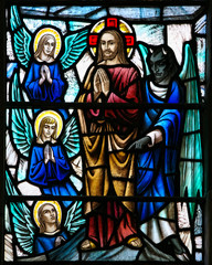 Fototapeta premium ST. JOHN'S, NEWFOUNDLAND, CANADA- JUNE 26, 2014: The devil trying to temp Jesus in a stained glass window from the Anglican Cathedral of St John the Baptist in St. John's, NFLD.