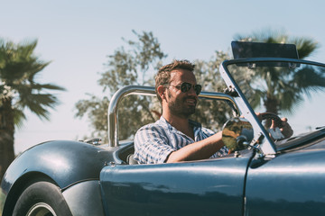 Man driving a convertible vintage car