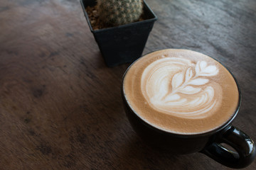 Close up of Cup of hot latte art coffee on wooden table
