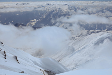 Fototapeta na wymiar Breathtaking panorama of snowy mountains range in Ski resort Gudauri, Georgia. Panoramic view on speed riding in high peaks. Caucasus 