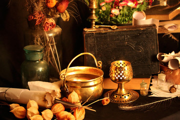 Antique Magic Book. Witchcraft Peacock feathers and candle background. Black candle Magic Ritual.