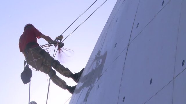 the industrial climber prepares for work at height early in the morning