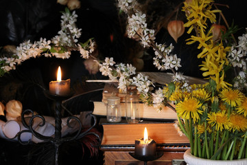 Antique Magic Book. Witchcraft Peacock feathers and candle background. Black candle Magic Ritual.