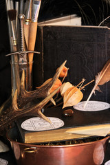 Antique Magic Book. Witchcraft Peacock feathers and candle background. Black candle Magic Ritual.