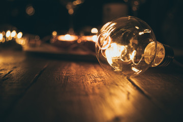 Light bulb with blurry background on dark brown wood table