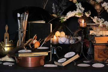 Fototapeta na wymiar Black candle Magic Ritual. Antique Magic Book. Witchcraft Peacock feathers and candle background.