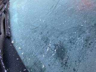 Frozen window of a car in winter