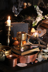 Black candle Magic Ritual. Antique Magic Book. Witchcraft  Peacock feathers and candle background.