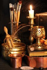 Black candle Magic Ritual. Antique Magic Book. Witchcraft  Peacock feathers and candle background.