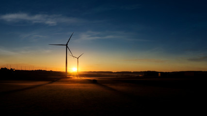 Obraz premium Windmill at Sunset . Wind turbines farm . 