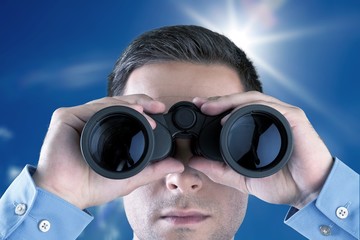 Young handsome man in shirt  with binoculars