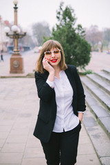 Fototapeta premium business woman with phone walk in the city
