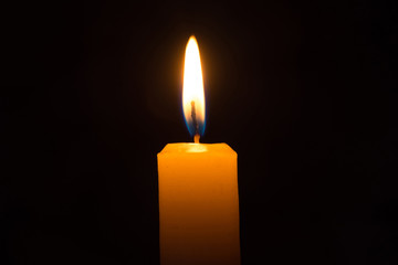 Burning candle in dark.