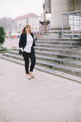 Business Women Style. Woman Going To Work Walking Downstairs. Portrait Of Beautiful Smiling Female In Stylish Office Clothes Going Old Town.