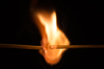 Burning matches in dark.