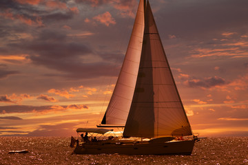 sailing boat at sunset in golden light