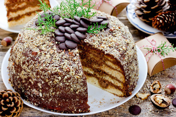 Christmas cake, homemade layer cake with chocolate and nuts for winter holidays