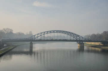 Fototapeta na wymiar Bridge over the river in the fog